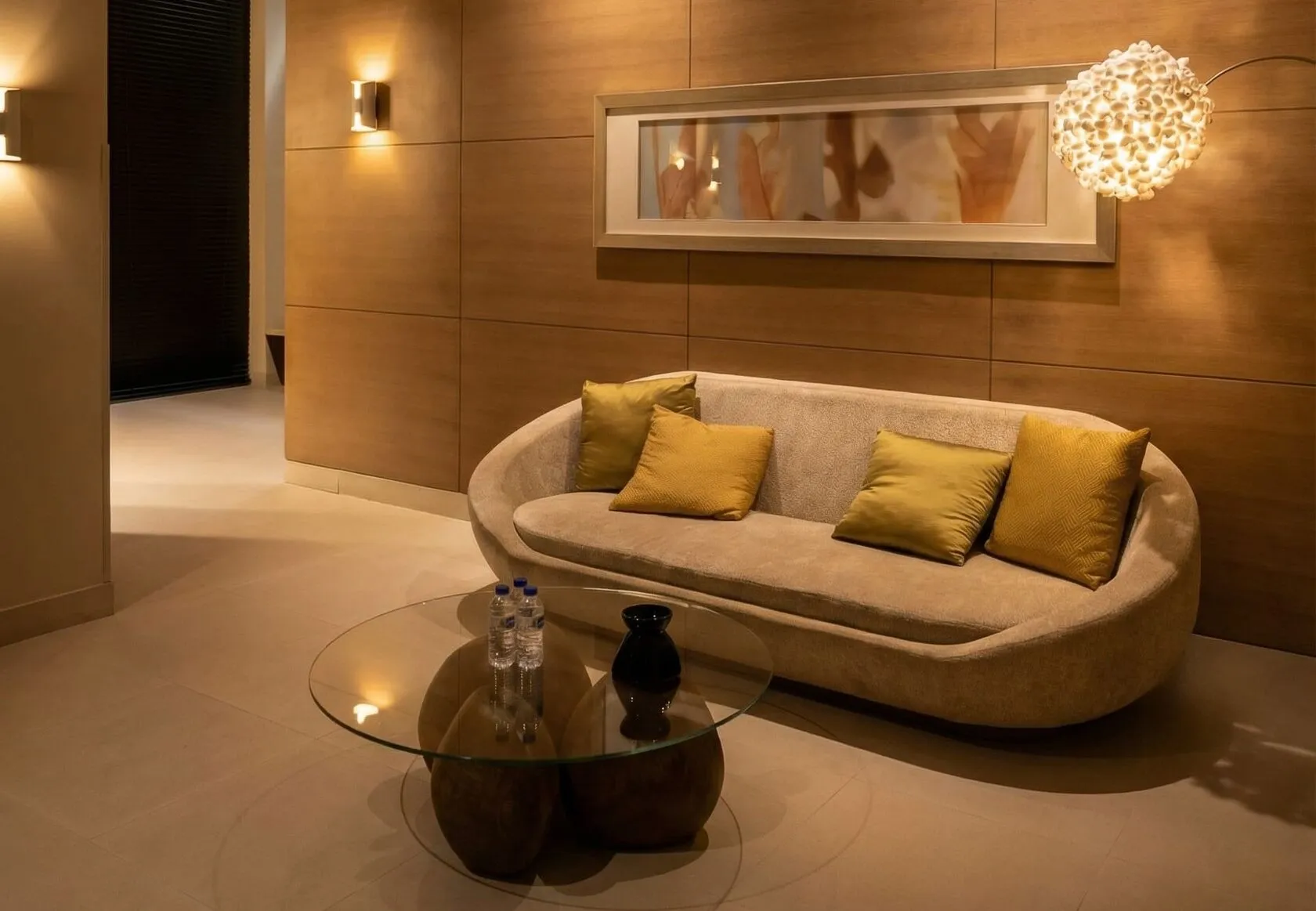 Doral Spa relaxation lounge with a curved sofa and warm lighting