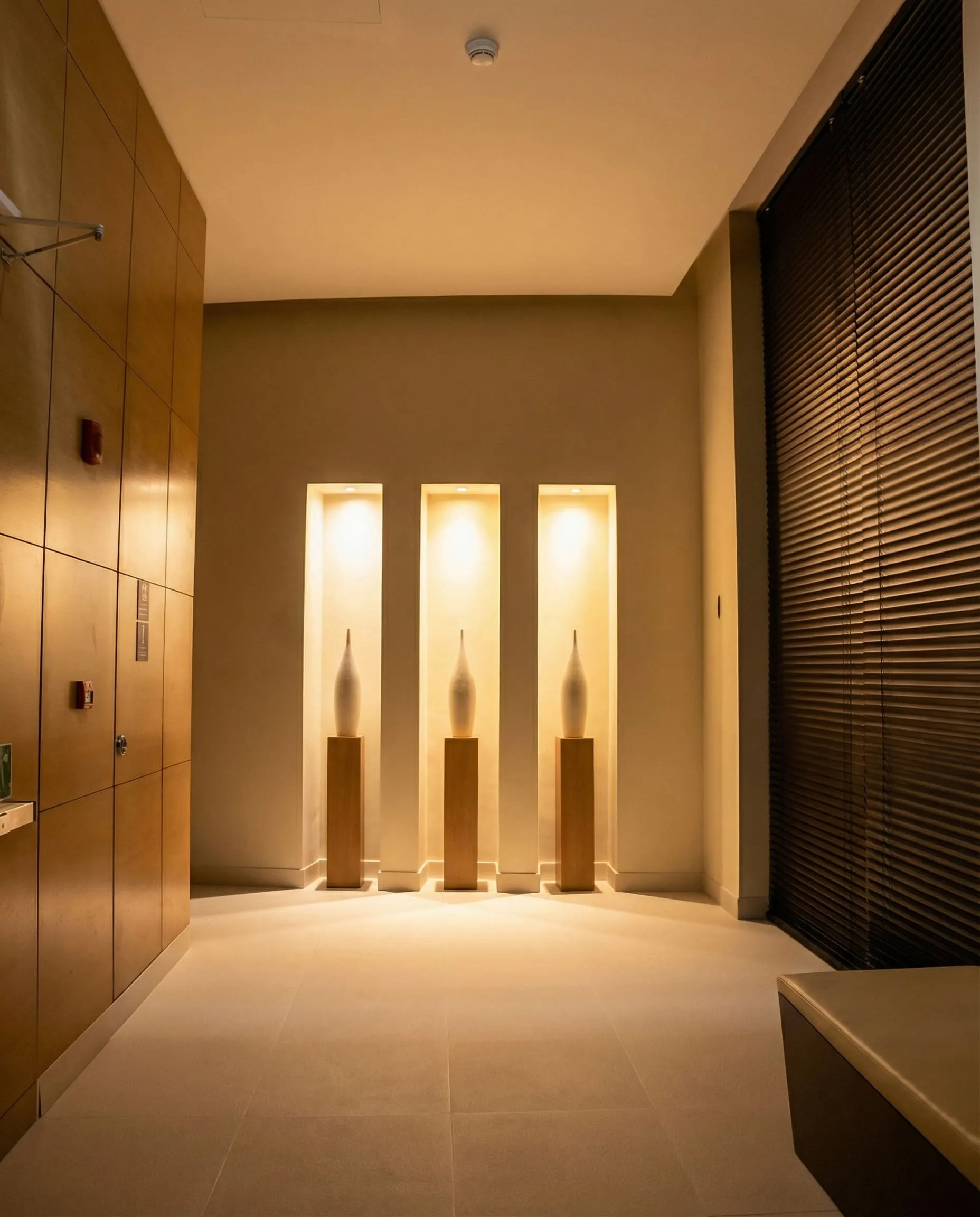 Doral Spa interior with softly lit display niches and warm wood panelling